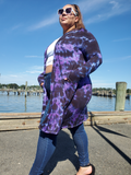 a mostly sideway shot; Ana is wearing a small crop tee under this cardigan, and a pair of blue skinny jeans with heels. Her hands are in the pockets, and her white framed sunglasses look very stylish with this assemble.