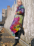 leaning againts the fence, one foot pressed on the wood knee high