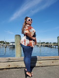 A side view of Ana, she's showing off her beautiful plus curves. Here she has a belt wrapped around, securing this cardigan on her body. An a looks like a superstar with her white framed shades, blue skinny jeans and high heels!