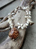 photographed on a branch; crocheted hemp short necklace