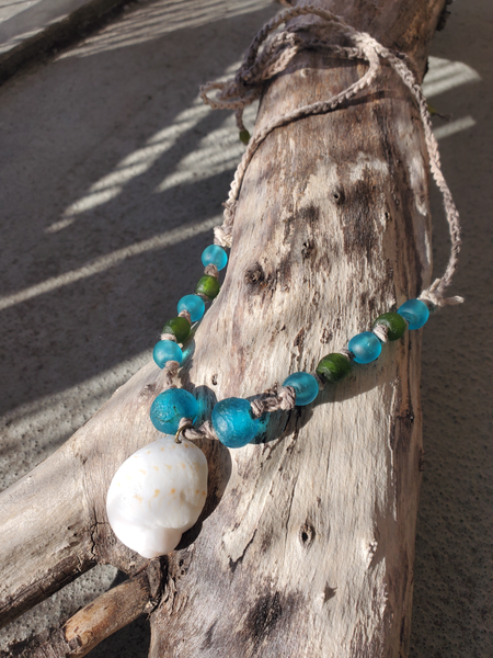 upcycled blue and green African glass beads knotted on a hemp cord, with adjustable long ties, and a large white Moon shell pendant