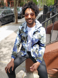 Daniel is sitting on some steps, the jacket is open on the front. The sample he's modeling is a medium, but because of his extra long arms, he'd really need a size large.