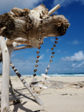 a pretty beach mood shot - necklace hanging from a branch