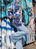 I'm leaning up against a graffiti wall, the jacket is open, sleeves rolled, my hands are in my jeans pockets.