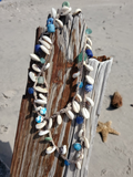cowrie shells mixed with blue & green glass beads (reclaimed African trade beads), crocheted on a hemp cord