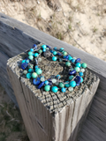 Multicolored beaded bracelet on a wooden surface with a natural background