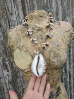 same necklace on the form, my hand is  under the large shell pendant to show size and ration