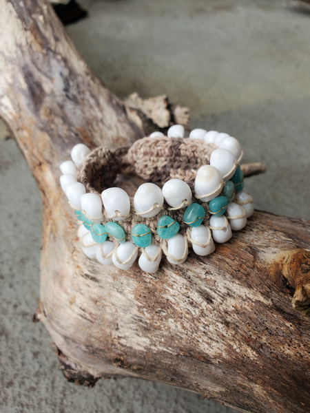 The base of this no metal bracelet is crocheted with hemp. The White Moon shells and amazonite beads are stitched on 