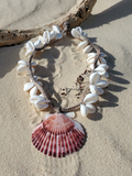 White cowrie shell necklace with a pink shell