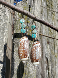 Olive Shells Long Earrings with Amazonite Beads
Crocheted & Beaded Hemp Earrings
Sea Shells Dangle Earrings
Design: OLIVE SHELLS-AMAZONITE
I crocheted the "stick" part of the earrings with a natural hemp cord (it is a long piece folded and hand-stitched together for a better structure - double layer!), hand-sew the Amazonite beads on top, and used brass jump rings to attach the lever back top and the drilled sea shells.
These earrings measure just under 3½" from top to bottom.
****The crocheted-beaded pa