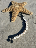 the bracelet is laid out flat, with the knob nd loop details very visible