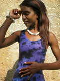 modeled with a matching bracelet and a black-purple tie dye dress