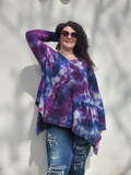 Fuzzy sweater in purple tie dye, long sleeves, fishtail hem, V-neck line.