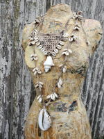 the longer necklace photographed on the form along with a different shell statement design - not offered in this listing