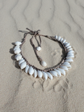 shells crocheted closely next to each other, displayed on the sand
