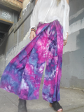 Person wearing a colorful p with a blurred backgroundrple-pink ice dye wrap pants