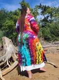 Ana on the beach wearing my long ribbed rayon jersey basic cardigan with pockets and extra long sleeves with thumbholes. The hand dyed rainbow colors are super bright! This photo is showing Ana's back.