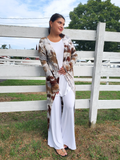 a front view; Dena has a white loose tank and white Palazzo pants under the duster. The sleeves are extra long with a thumbhole!