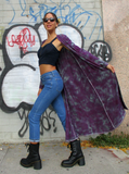 Here we can see Marian's pretty model body from the side; she is wearing a fun black top, blue skinny jeans with boots, and the long cardigan is floating after her