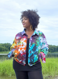 y size 1x pretty friend Lisa modeling a size 2xl Rainbow galaxy tie dye denim jacket - it is a juniors Plus style, must buy 1-2 sizes up!. Cropped shape, collar, 4 front, 2 inner pockets, metal buttons, soft stretchy lightweight denim fabric, mostly cotton, holding the dye very nicely.