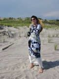 Stephanie is holding the string of the straw hat with both of her hands. You can see the left side of the cardigan with the pocket.