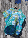 this kaftan photographed by itself, hanging on a fence