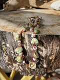 crocheted on a thin nylon cord, sliced green Turbo and Puka shells are alternating on this 21' necklace.