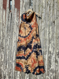 Tie-dye dress hanging on a wooden fence