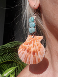 in my ear - it is 4" long from top to bottom! the shell is 2" wide