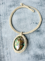Necklace with a pendant on a textured surface