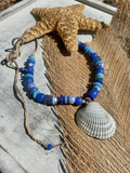 Necklace with blue beads and starfish on a wooden surface