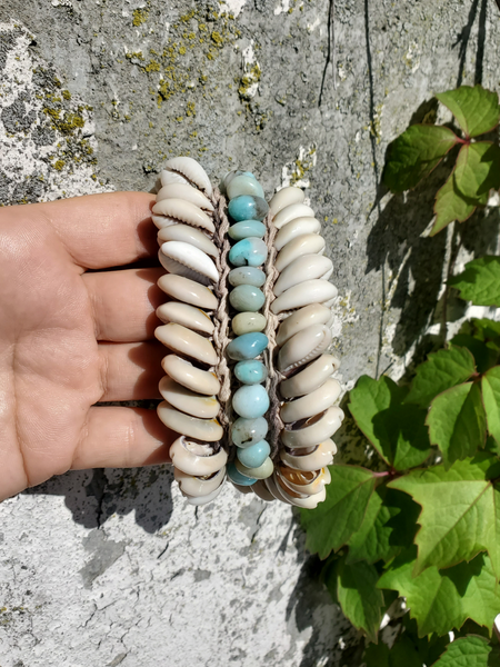 crocheted hemp base, added sliced cowrie shells, hand stitched amazonite nugget beads, tie closure with shell tips