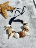Necklace with seashell pendants on a black crocheted hemp base
