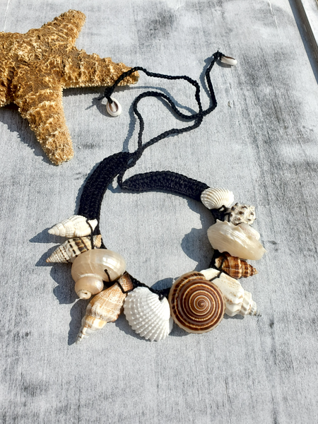 Necklace with seashell pendants on a black crocheted hemp base