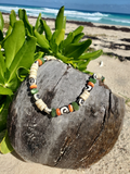 Beaded necklace on a coconut shell with a beach background