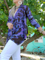 I'm modeling a long sleeve open front, draped neck, asymmetric front hem. I hand dyed this  here in black first, then added lavender to cover the white areas.. I'm standing  front of a tree, holding the open front with one hand.