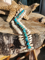 crocheted hemp base with ties, beaded with 80 cut cowrie shells and 45 sea sediment beads