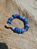 Blue beaded bracelet on a textured wooden surface