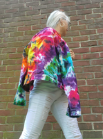 I'm wearing a pair of white jeans and tank top under the rainbow denim jacket; in this photo the jacket is hanging on my right shoulder for style