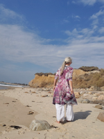 a mood shot at the beach, a back view of this dress