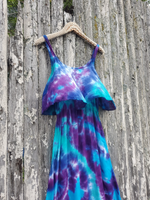 The same dress hanging on our fence; the wind is blowing the flouncy top.  A close up shot.