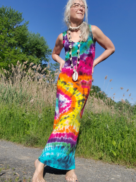 im a size small, modeling a small bodycon/formfitting maxi dress, a tank dress, hand dyed in rainbow colors