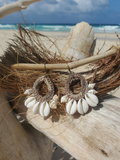 Crocheted earrings with shell accents on a beach setting