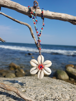 a 6-petal Cowrie shells flower pendant on a beaded hemp cord