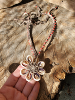 showing the back of the pendant: I crocheted a a base, then stitched on the 8 sliced cowrie shells and beads