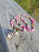 hot pink opal beads with amethyst, carnelian, jade & puka shell accents, and a black and white Hebrew cone shell pendant necklace