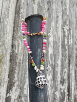 18" long crocheted beaded necklace with small gemstone beads (pink opal, carnelian, puka shells) and a black and white Hebrw Cone shell pendants. Lobster closure, 