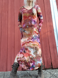 I am a size small, 5'3" woman modeling this dress in a pretty ice dye combo; brown-khaki-rust-dusty purple. The dress is long, has side slits, side pockets (I have my hands in them), a V-neck and hood. I'm wearing a funky pair of high top canvas boots.