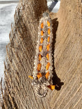 Bracelet with orange stones on a wooden surface