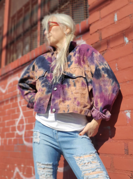 a size large cropped denim jacket - original color is mauve, I hand dyed it in navy and purple shades. I'm modeling it at a brick wall; I'm only a size small